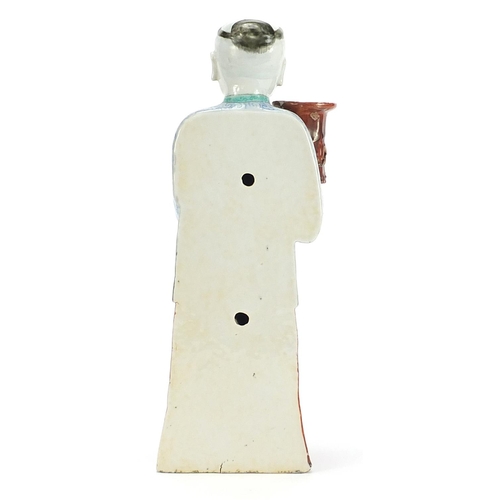 718 - Chinese porcelain figural candlestick of a robed gentleman hand painted in the famille rose palette,... 