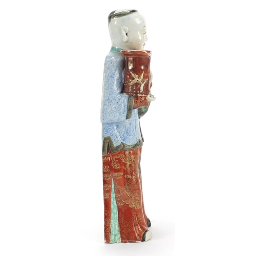 718 - Chinese porcelain figural candlestick of a robed gentleman hand painted in the famille rose palette,... 