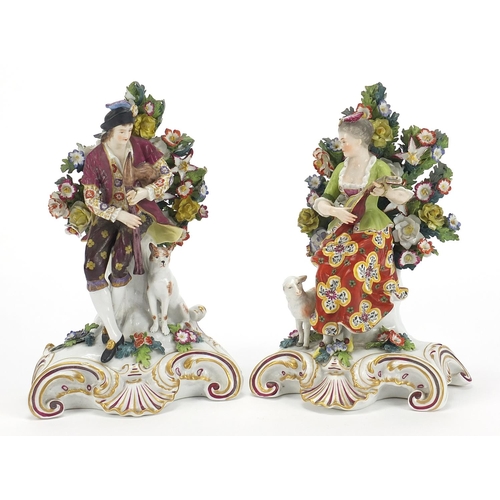 867 - Pair of Chelsea style porcelain figures with dogs and floral encrusted backs, each approximately 21c... 