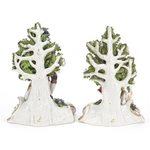 867 - Pair of Chelsea style porcelain figures with dogs and floral encrusted backs, each approximately 21c... 