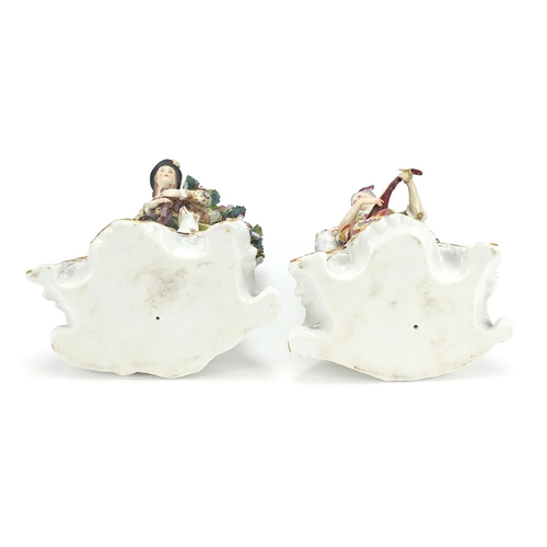 867 - Pair of Chelsea style porcelain figures with dogs and floral encrusted backs, each approximately 21c... 