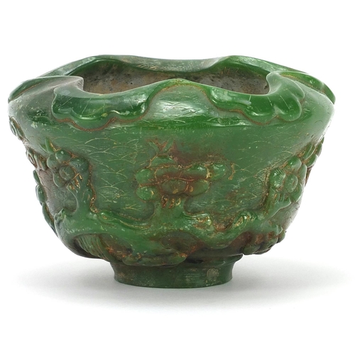 831 - Chinese green jade bowl carved with cranes in a landscape amongst prunus blossom, 13cm in diameter