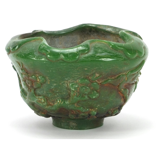 831 - Chinese green jade bowl carved with cranes in a landscape amongst prunus blossom, 13cm in diameter