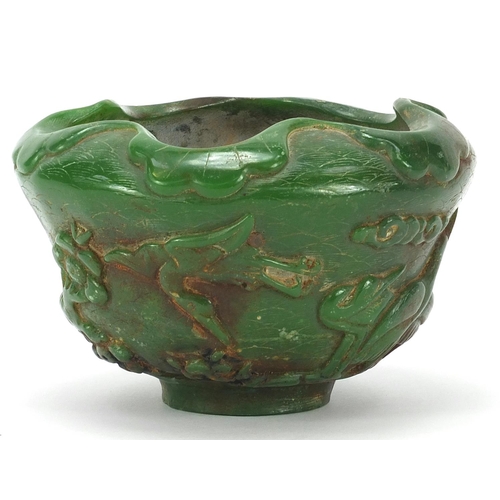 831 - Chinese green jade bowl carved with cranes in a landscape amongst prunus blossom, 13cm in diameter