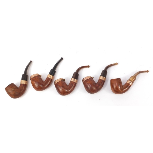 234 - Five vintage smoking pipes with gold coloured metal mounts, three with horn mouthpieces