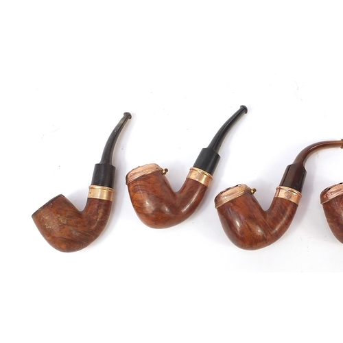 234 - Five vintage smoking pipes with gold coloured metal mounts, three with horn mouthpieces