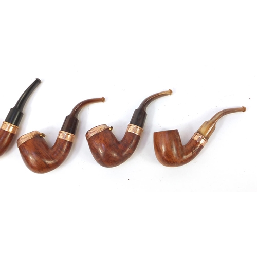 234 - Five vintage smoking pipes with gold coloured metal mounts, three with horn mouthpieces