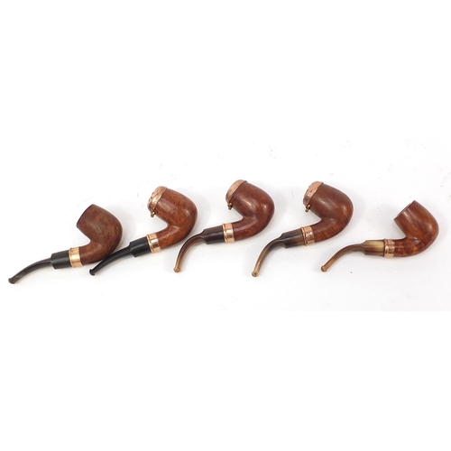 234 - Five vintage smoking pipes with gold coloured metal mounts, three with horn mouthpieces