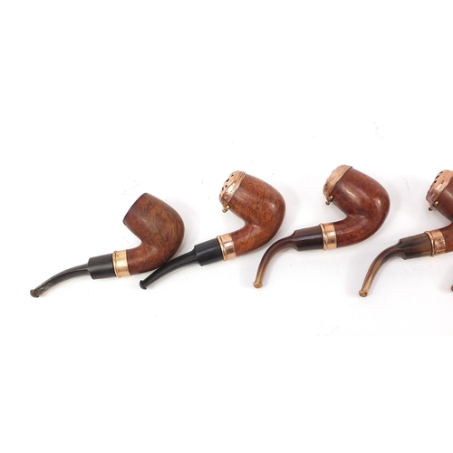 234 - Five vintage smoking pipes with gold coloured metal mounts, three with horn mouthpieces