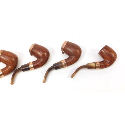 234 - Five vintage smoking pipes with gold coloured metal mounts, three with horn mouthpieces