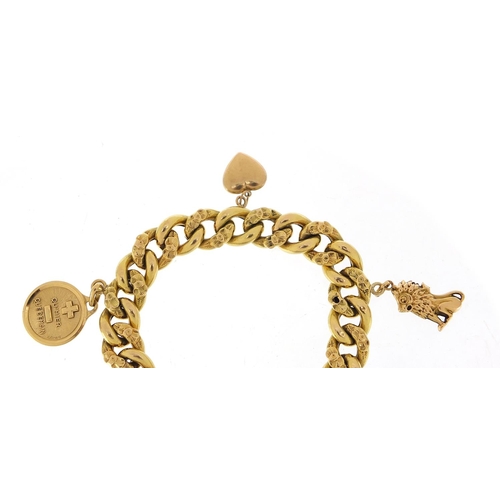 32 - Continental 18ct gold bracelet, probably French with a selection of gold charms including a seated l... 