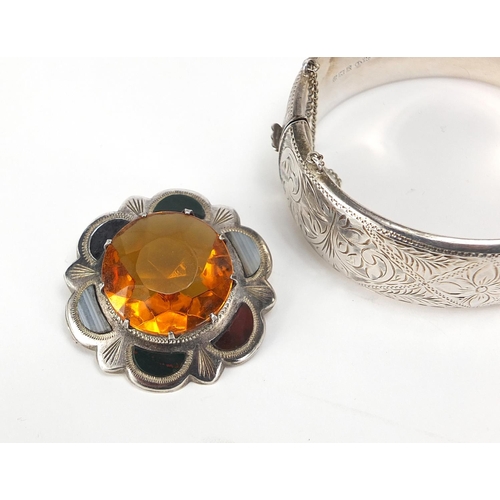 545 - Four silver bangles and a Scottish agate and citrine brooch, total 91.7g