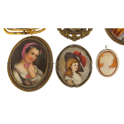 498 - Five antique porcelain portrait miniature brooches with gilt metal mounts and a silver cameo pendant... 