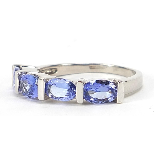 854 - 9ct white gold purple stone ring, possibly tanzanite, size N, 3.4g