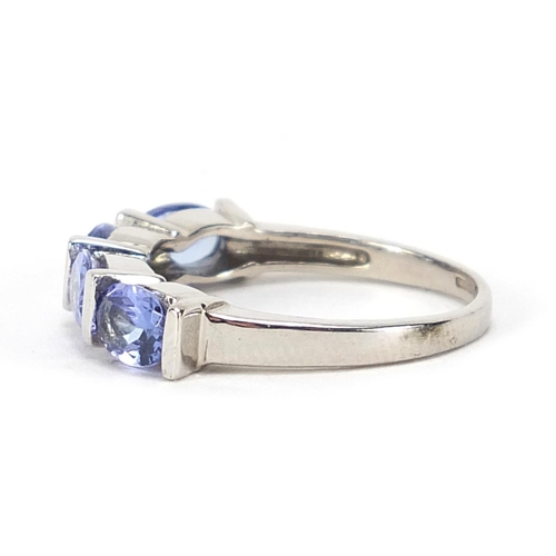 854 - 9ct white gold purple stone ring, possibly tanzanite, size N, 3.4g