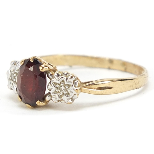 581 - 9ct gold diamond and garnet three stone ring, size U, 2.7g