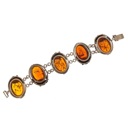 918 - Large naturalistic silver and amber bracelet, 20cm in length, 52.8g