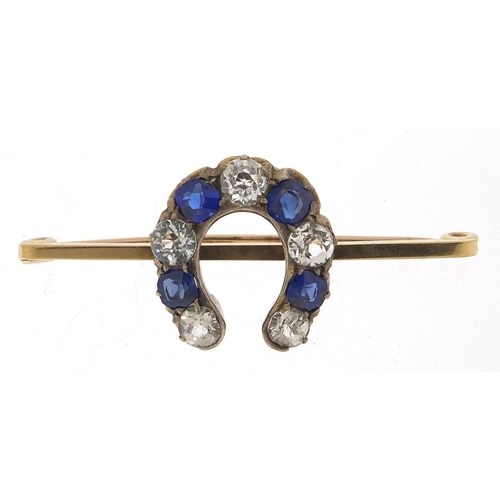 576 - 9ct gold white sapphire and blue paste horseshoe bar brooch, 4.5cm wide, 5.2g