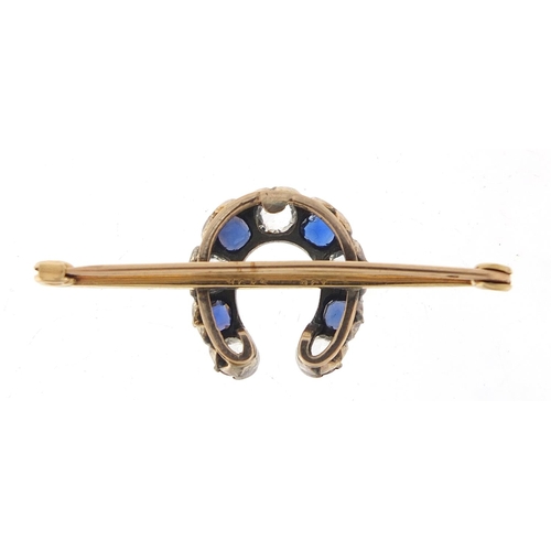 576 - 9ct gold white sapphire and blue paste horseshoe bar brooch, 4.5cm wide, 5.2g