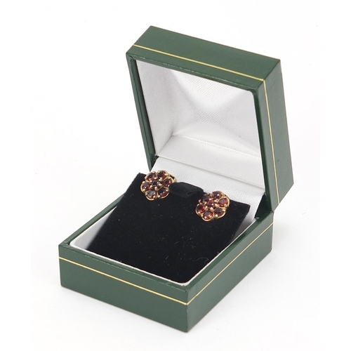 251 - Pair of 9ct gold garnet flower head clip on earrings, 1.0cm in diameter, 2.8g