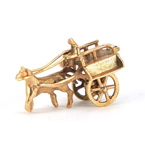 174 - 9ct gold horse drawn cart charm with rotating wheels, 2.5cm in length, 3.0g