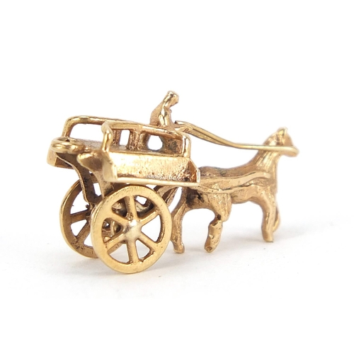 174 - 9ct gold horse drawn cart charm with rotating wheels, 2.5cm in length, 3.0g