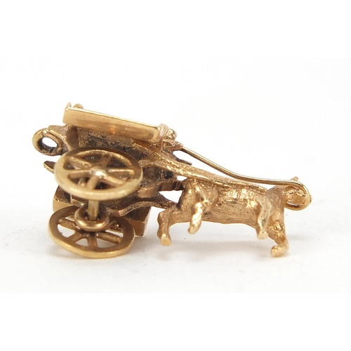 174 - 9ct gold horse drawn cart charm with rotating wheels, 2.5cm in length, 3.0g