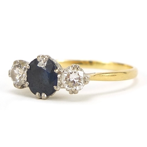 13 - Unmarked gold, sapphire and diamond three stone ring, the sapphire approximately 7mm x 6mm, the diam... 
