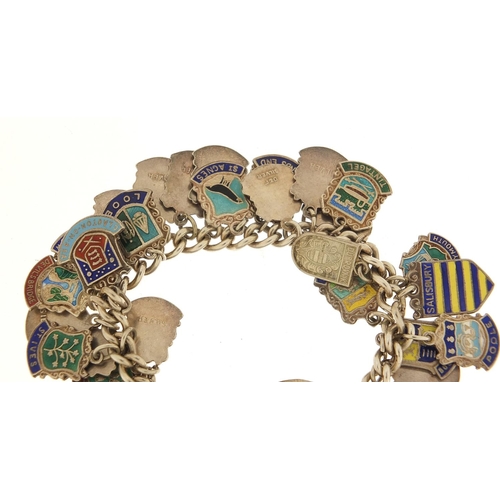 582 - Silver and enamel souvenir shield charm bracelet, 69.0g