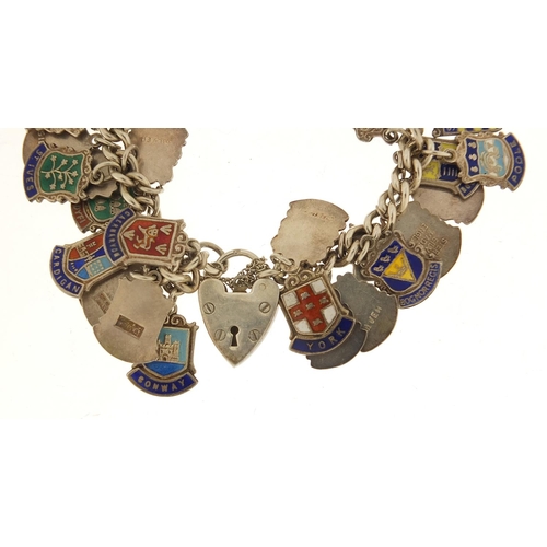 582 - Silver and enamel souvenir shield charm bracelet, 69.0g