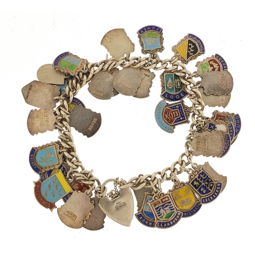 582 - Silver and enamel souvenir shield charm bracelet, 69.0g