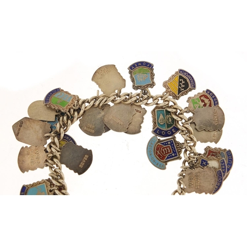 582 - Silver and enamel souvenir shield charm bracelet, 69.0g