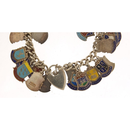 582 - Silver and enamel souvenir shield charm bracelet, 69.0g