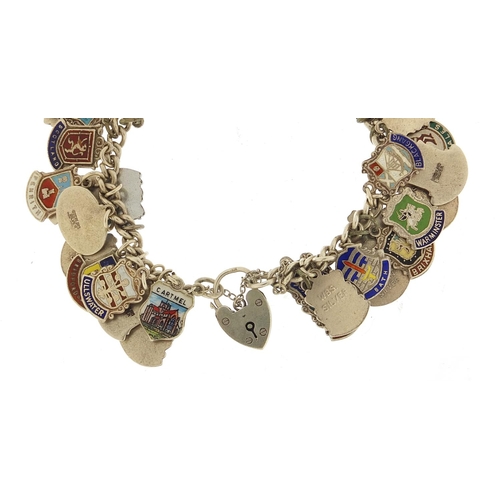 547 - Silver and enamel souvenir shield charm bracelet, 74.5g