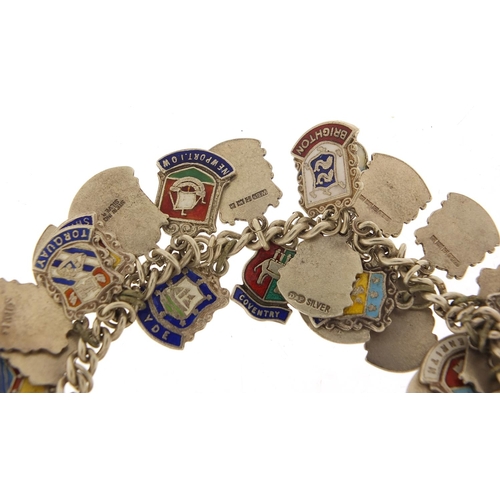 547 - Silver and enamel souvenir shield charm bracelet, 74.5g