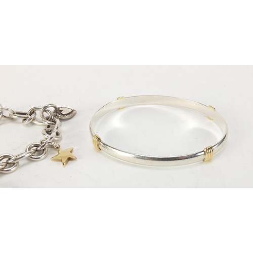 343 - Modern silver charm bracelet with 9ct gold and silver charms and a silver bangle, 74.5g