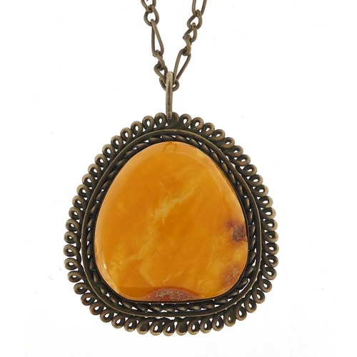 1072 - Large amber pendant with silver coloured metal mount and chain, the pendant 5cm high, total 23.8g