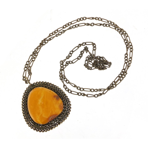 1072 - Large amber pendant with silver coloured metal mount and chain, the pendant 5cm high, total 23.8g