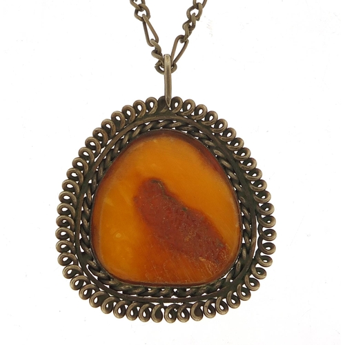 1072 - Large amber pendant with silver coloured metal mount and chain, the pendant 5cm high, total 23.8g