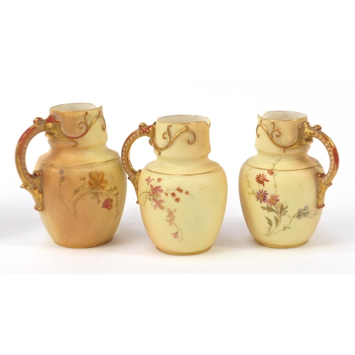 75 - Royal Worcester blush ivory comprising three jugs, pair of dishes and a side plate, each decorated w... 