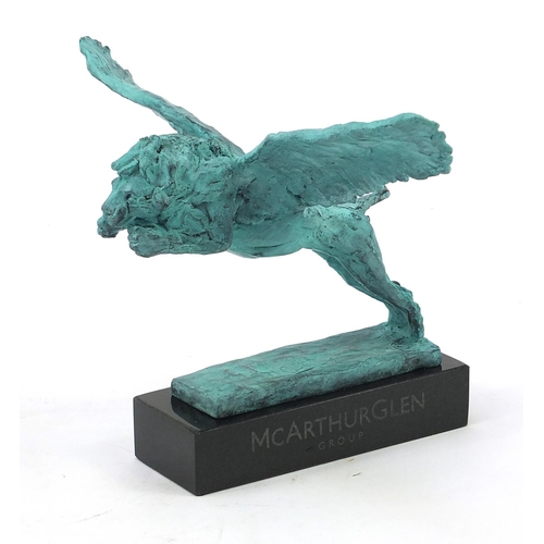 1079 - McArthur Glen Group, Verdigris bronze study of winged lion raised on a rectangular slate base with b... 