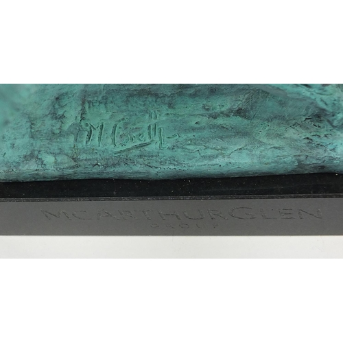 1079 - McArthur Glen Group, Verdigris bronze study of winged lion raised on a rectangular slate base with b... 