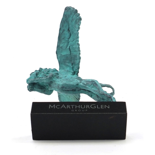 1080 - McArthur Glen Group, Verdigris bronze study of winged lion raised on a rectangular slate base with b... 