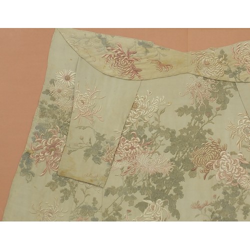 295 - Chinese silk robe embroidered with flowers, framed and glazed, 161cm x 119.5cm excluding the frame