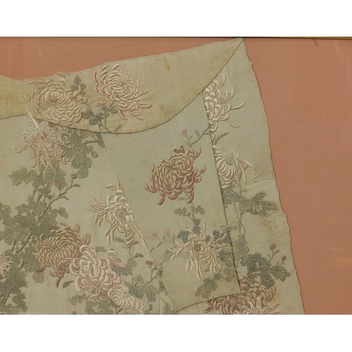 295 - Chinese silk robe embroidered with flowers, framed and glazed, 161cm x 119.5cm excluding the frame