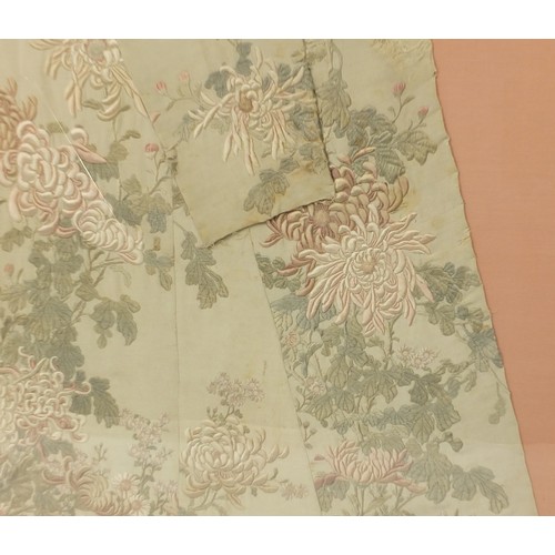 295 - Chinese silk robe embroidered with flowers, framed and glazed, 161cm x 119.5cm excluding the frame