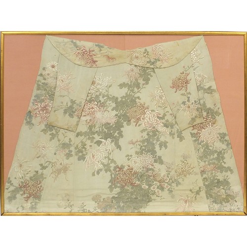 295 - Chinese silk robe embroidered with flowers, framed and glazed, 161cm x 119.5cm excluding the frame