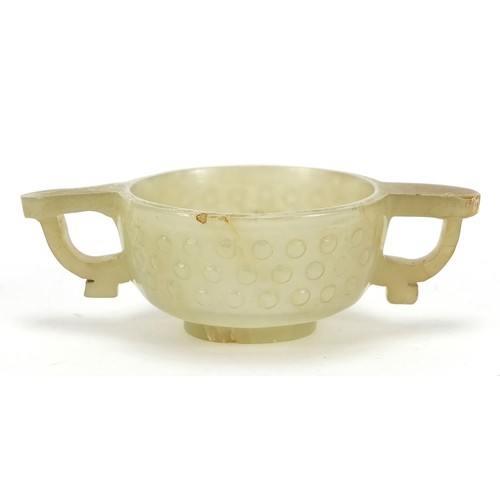 111 - Good Chinese carved celadon jade libation cup with twin handles, 9cm wide