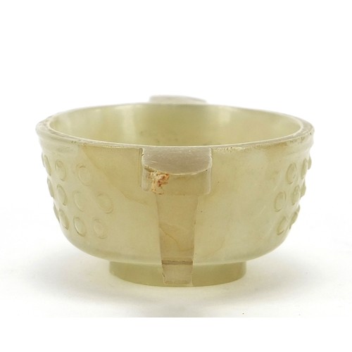 111 - Good Chinese carved celadon jade libation cup with twin handles, 9cm wide