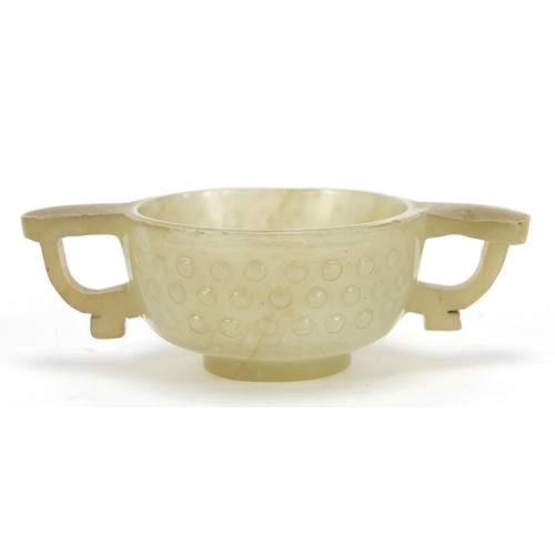 111 - Good Chinese carved celadon jade libation cup with twin handles, 9cm wide